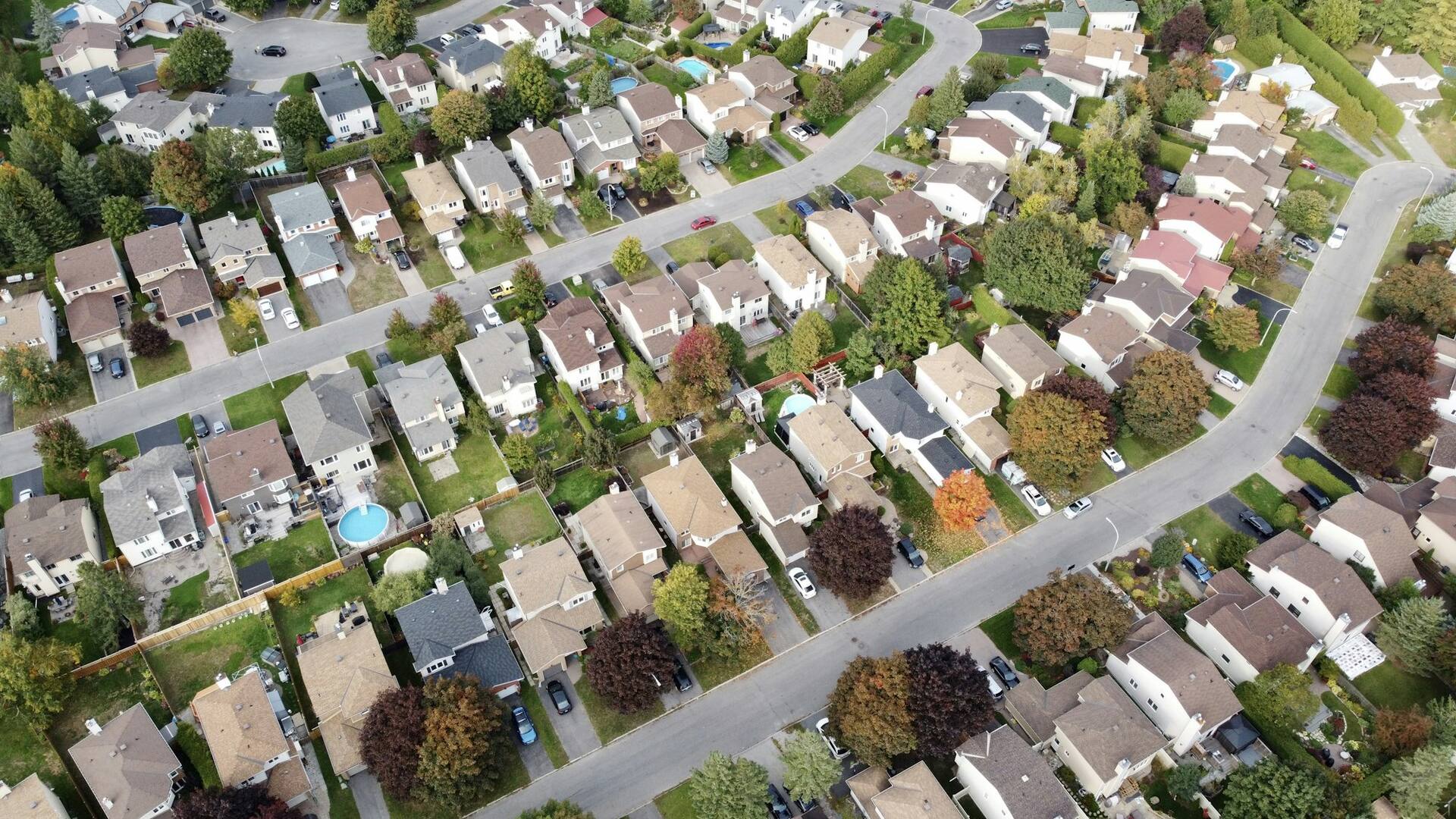 Aerial view of a dense grid of residential plots and streets
