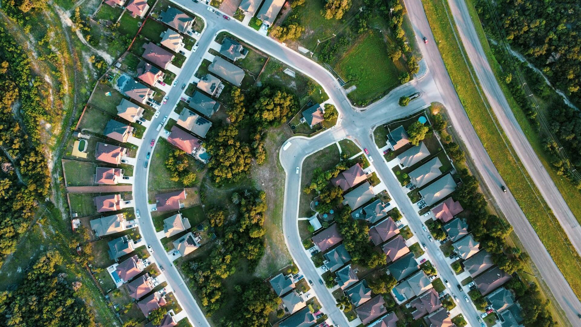 Aerial view of winding suburban streets lined with individual house plots